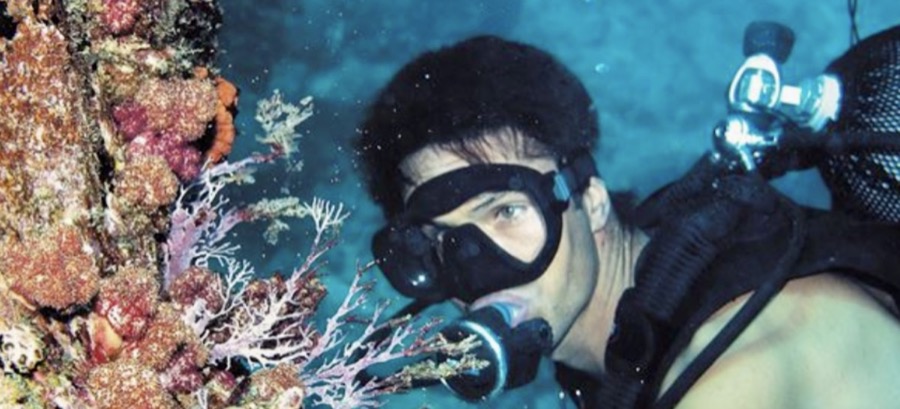 Scuba diver above a coral reef