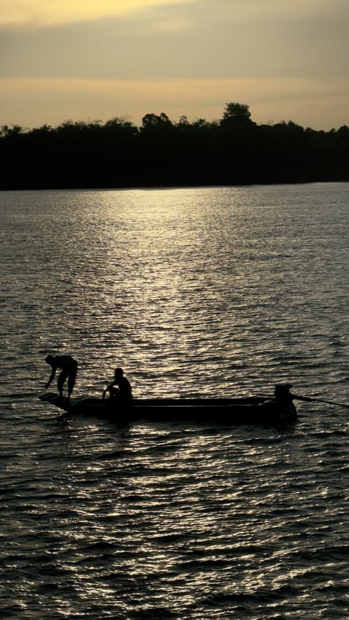 Fishing silhouette on a river at sunset