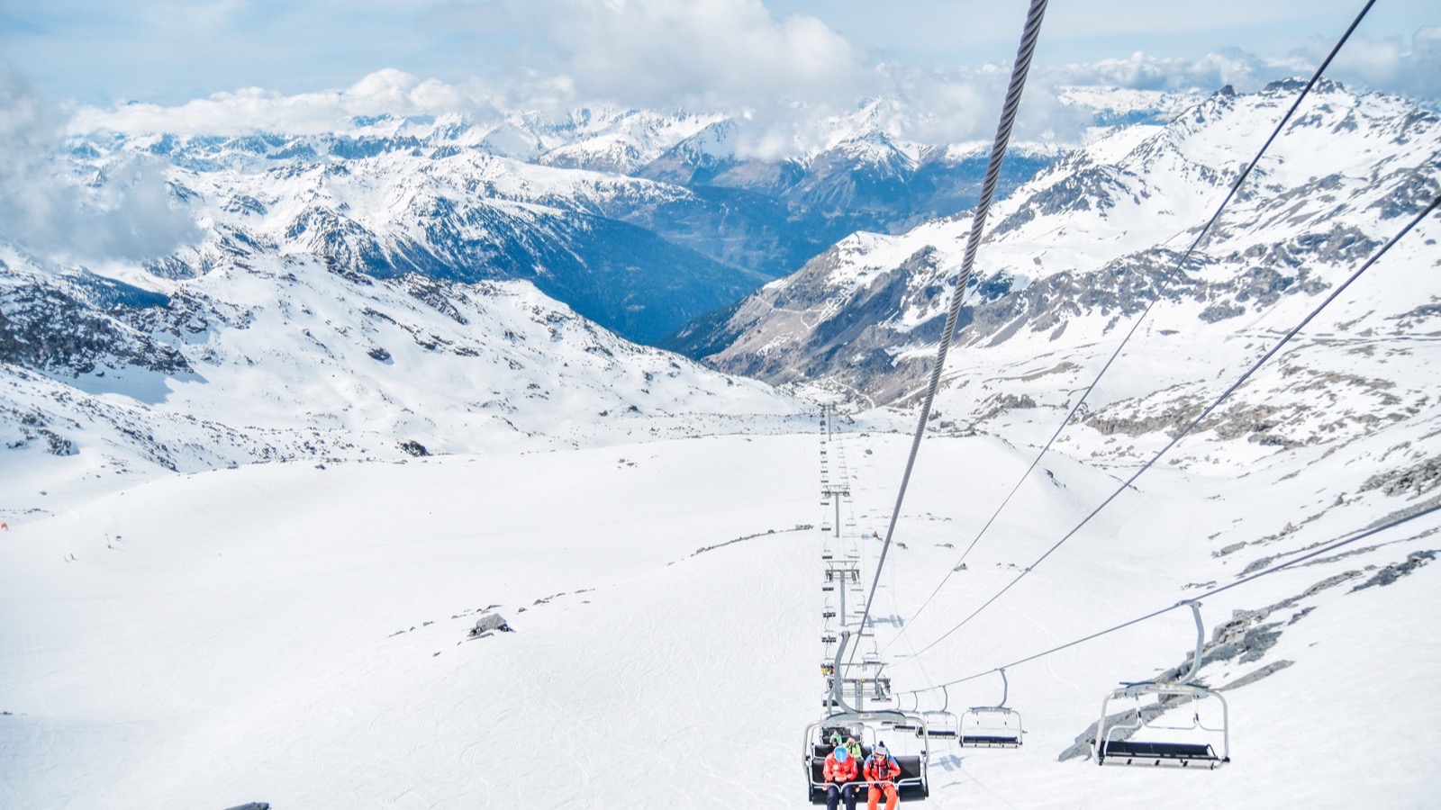 Snow resort chairlift above alpine runs